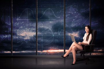 Wall Mural - Businesswoman holding laptop in office room with graph charts on