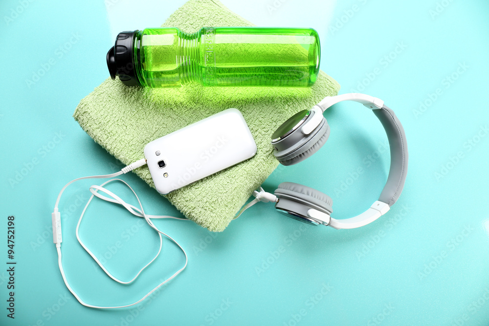 Headphones and sport equipment on blue background
