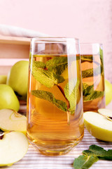 Canvas Print - Glasses of apple juice with fruits and fresh mint on table close up