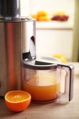 Poster - Juicer and orange juice on kitchen table