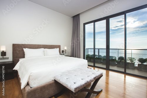Fotografie, Tablou Modern comfortable, nicely decorated bedroom with seascape view