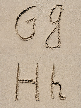 Sand font or letter set or collection on an exotic beach near the sea in summer