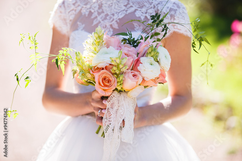 Fotografie, Obraz beautiful wedding bouquet in the hands of the bride