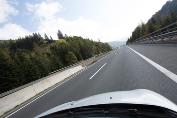 Road, green meadows, blue sky