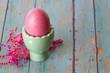 Pink Easter Egg in an Egg Holder on a textured background