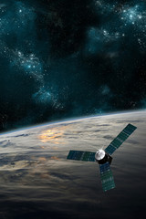 Wall Mural - a satellite orbits earth - elements of this image furnished by nasa.