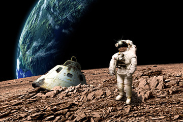Wall Mural - a stranded astronaut surveys his situation - elements of this image furnished by nasa.