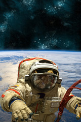 Wall Mural - a cosmonaut floats in space. - elements of this image furnished by nasa.