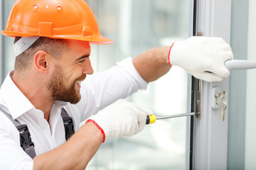 Cheerful male repairman is working with joy