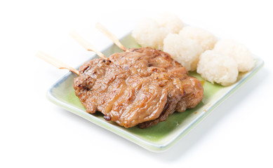 grilled pork and sticky rice on wood background