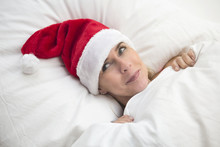 Woman In Bed With Santa Hat