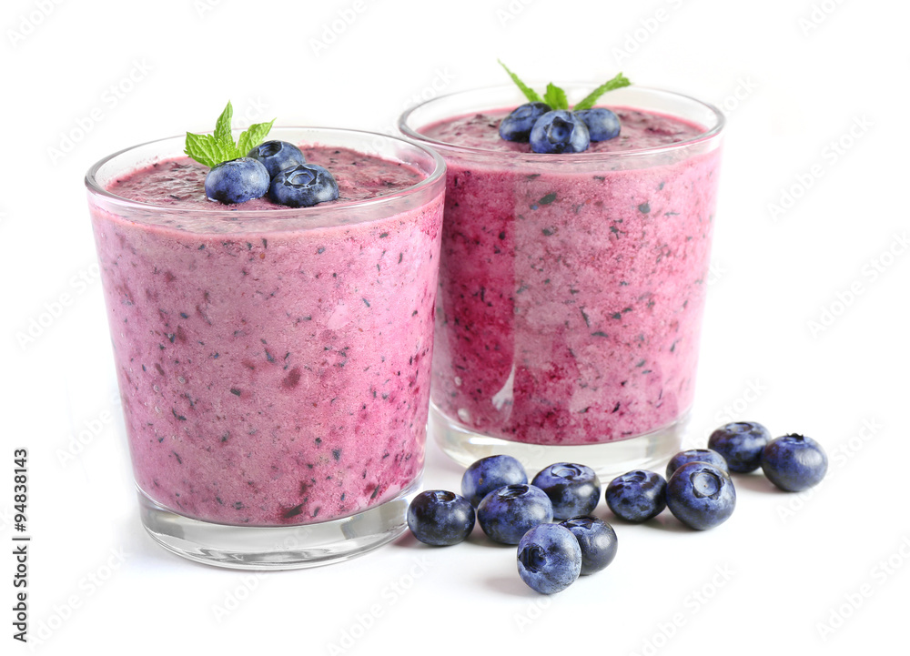 Glass of blueberry smoothie isolated on white