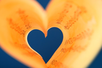 Sticker - Book pages curved into heart shape on blue background