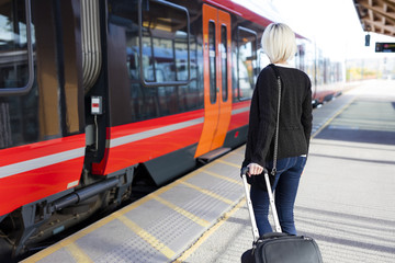 Young woman at a outdoor train terminal