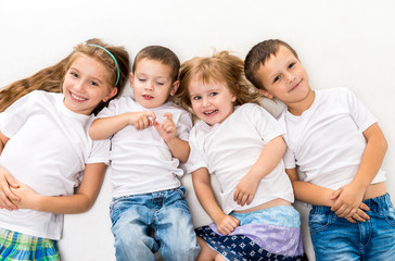 Wall Mural - children in white shirts lying on the floor