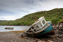 Abandoned Fishing Boat Lying On A Rocky Beach On The Isle Of Lewis, Outer Hebrides, Scotland, UK, Europe 