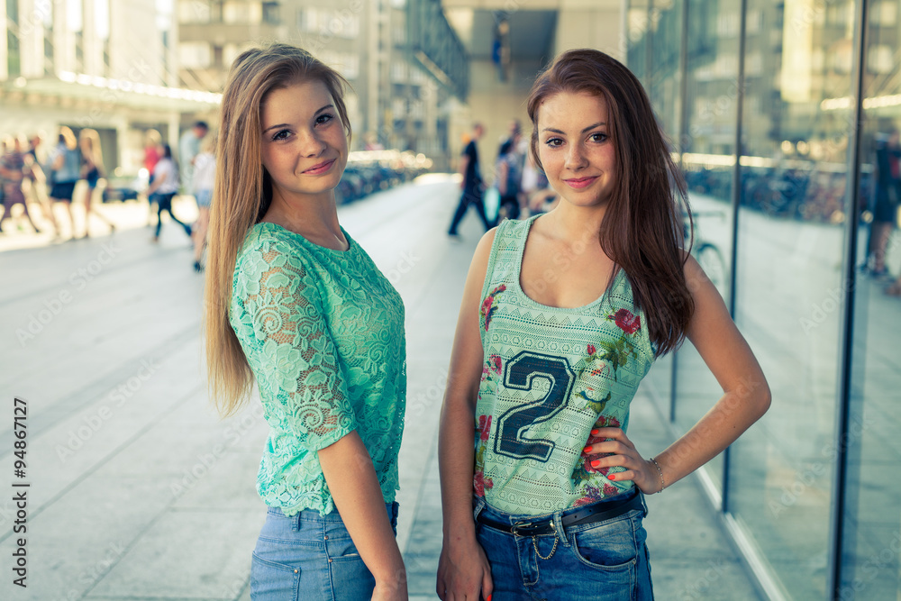Two pretty girls. They’re best friends. Outdoor photo. - obrazy, fototapety, plakaty 