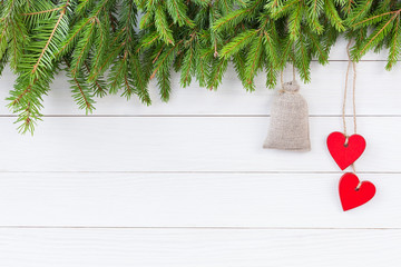 Christmas background. Christmas fir tree with decoration on white wooden board background with copy space. 