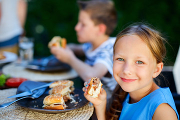 Wall Mural - Little girl eating burger