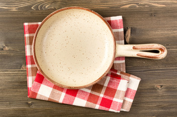 Empty serving ceramic pan on wooden table