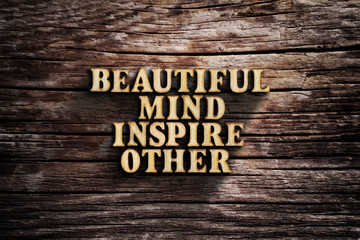 Beautiful mind inspire other. Words on old wooden board.