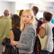 © kasto - Young blond caucsian woman waiting in line.