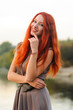 © pliekhova - Outdoors portrait of beautiful young woman with red hair