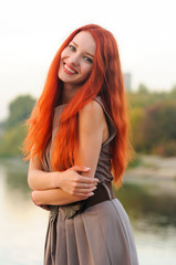 Sticker - outdoors portrait of beautiful young woman with red hair