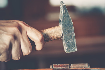 male Hand holding hammer