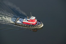 A Aerial View Of A Bright Red Tug Boat Outside Of Portland Maine