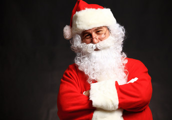 Wall Mural - Photo of happy Santa Claus in eyeglasses looking at camera