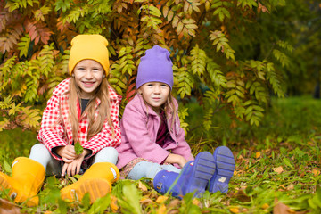 Wall Mural - Little adorable girls at warm sunny autumn day outdoors