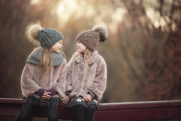 Wall Mural - Little adorable girls at warm sunny autumn day outdoors