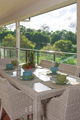 Wall Mural - Table setting on dining table in patio in the afternoon sun.