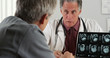 © Mark Adams - Doctor discussing elderly patient's mri scans