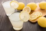 Fototapeta Góry - lemonade with fresh slice lemon on wooden table