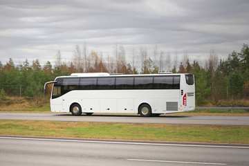Wall Mural - white coach bus on motorway on a cloudy day