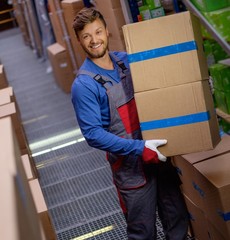 Poster - Porter carrying boxes in a warehouse