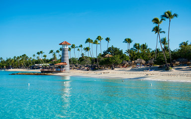 Wall Mural - Paradise tropical island in Dominican Republic. White sand, blue sea, clear sky and  lighthouse on shore