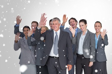 Canvas Print - Composite image of smiling business team waving at camera