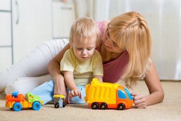 Wall Mural - mother with child playing together at home