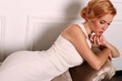 beautiful young woman with short red hair in retro style,wears elegant white dress