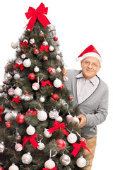 Sticker - Senior man posing behind a Christmas tree