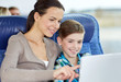 © Syda Productions - happy family with tablet pc sitting in travel bus