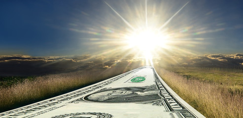 Money road to success. Sunrise panorama. 1 (one) USD as the road to success. The beautiful panoramic area of sunrise on background is free for your text.