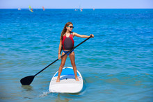 Kid Paddle Surf Surfer Girl With Row In The Beach