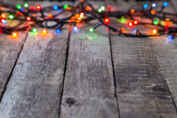 Christmas lights on wooden background