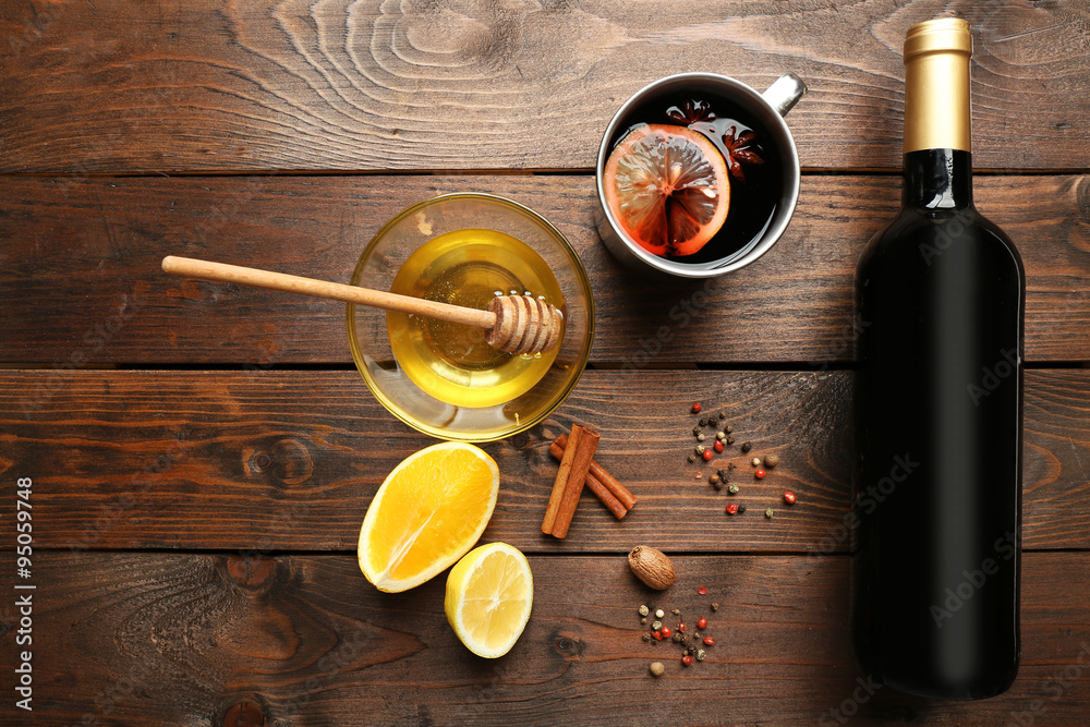 Composition of mulled wine and citrus on wooden background