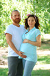 © Africa Studio - Happy family waiting for baby's birth embracing  in the park