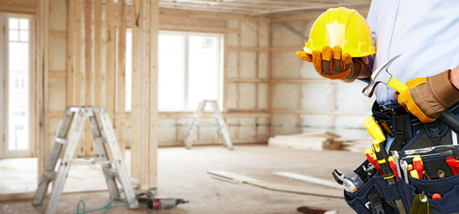 Builder handyman with construction tools.